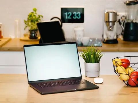 A laptop open on a kitchen counter