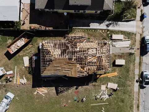 A house roof opened down to its framing, seen from above
