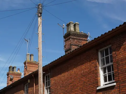 Brick chimneys along the roofs of attached houses