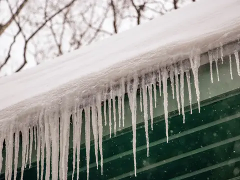 Icicles along a snow-covered roof edge