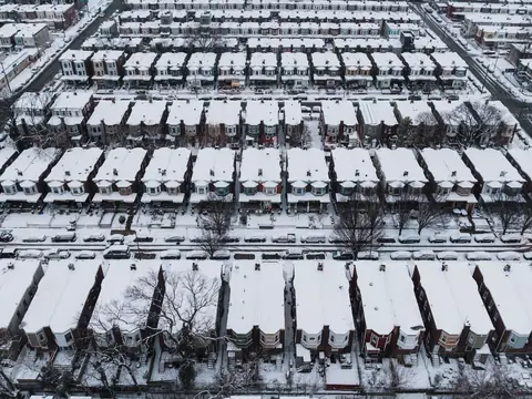Snow covering the roofs of attached houses, seen from the air