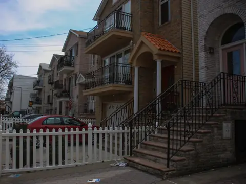 Attached houses with front stoops on a street in the Ironbound, Newark