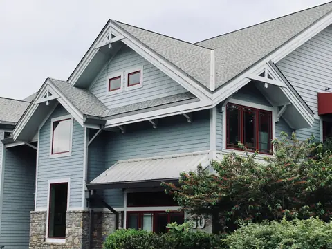 A detached house with a pitched shingle roof