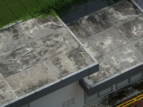 Seams and patches on a weathered flat roof, seen from above