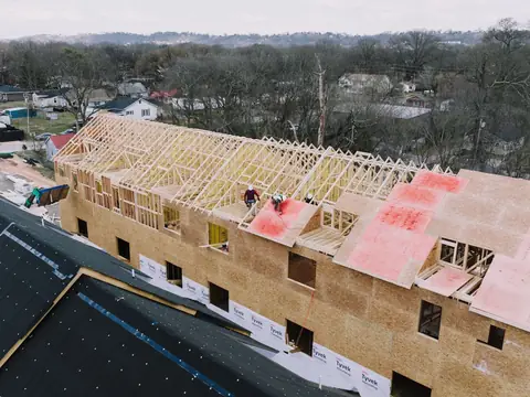 A row of attached houses under construction, seen from above