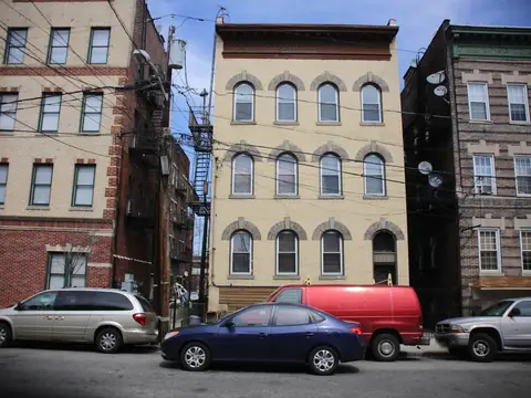 Attached brick walk-ups on a street in Newark